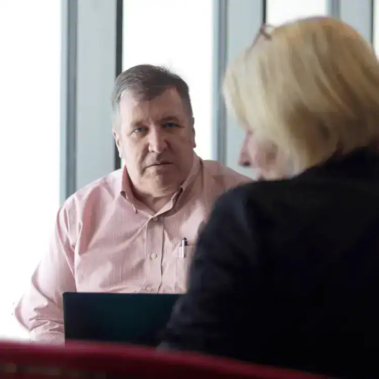 Business professionals discussing training programmes in a corporate setting.