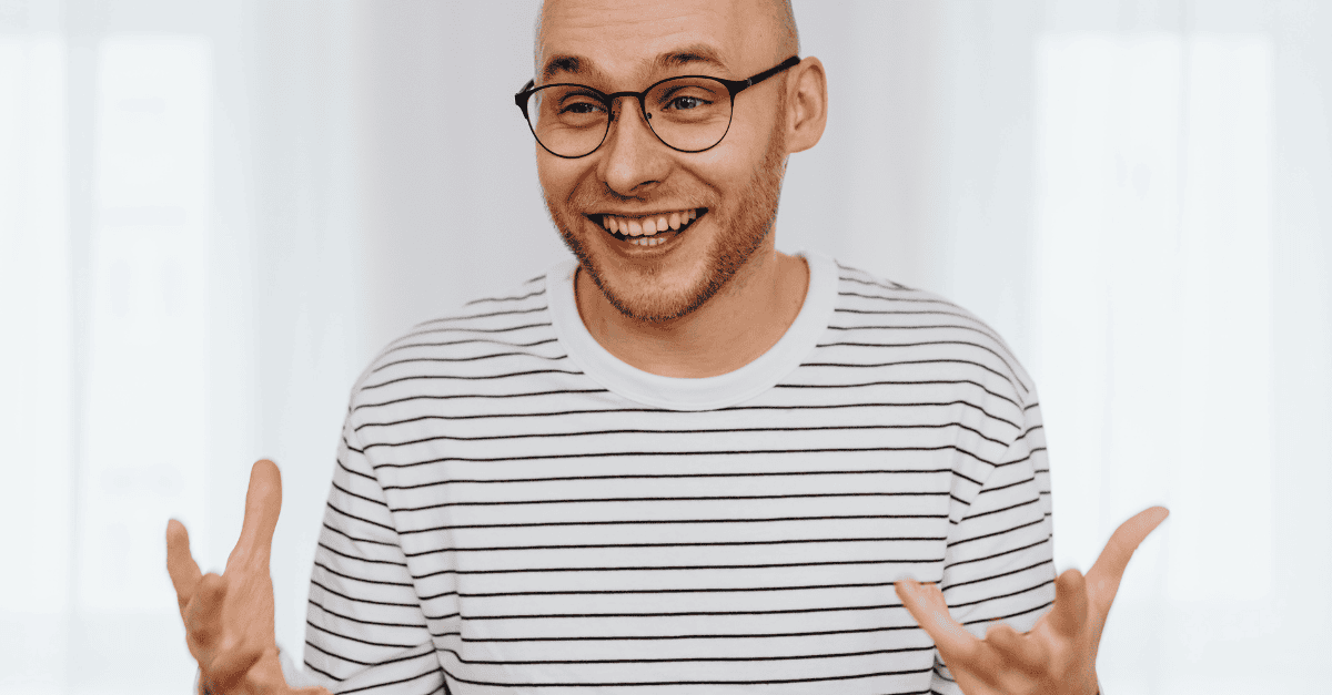 Happy man collaborating with team, smiling and gesturing confidently.