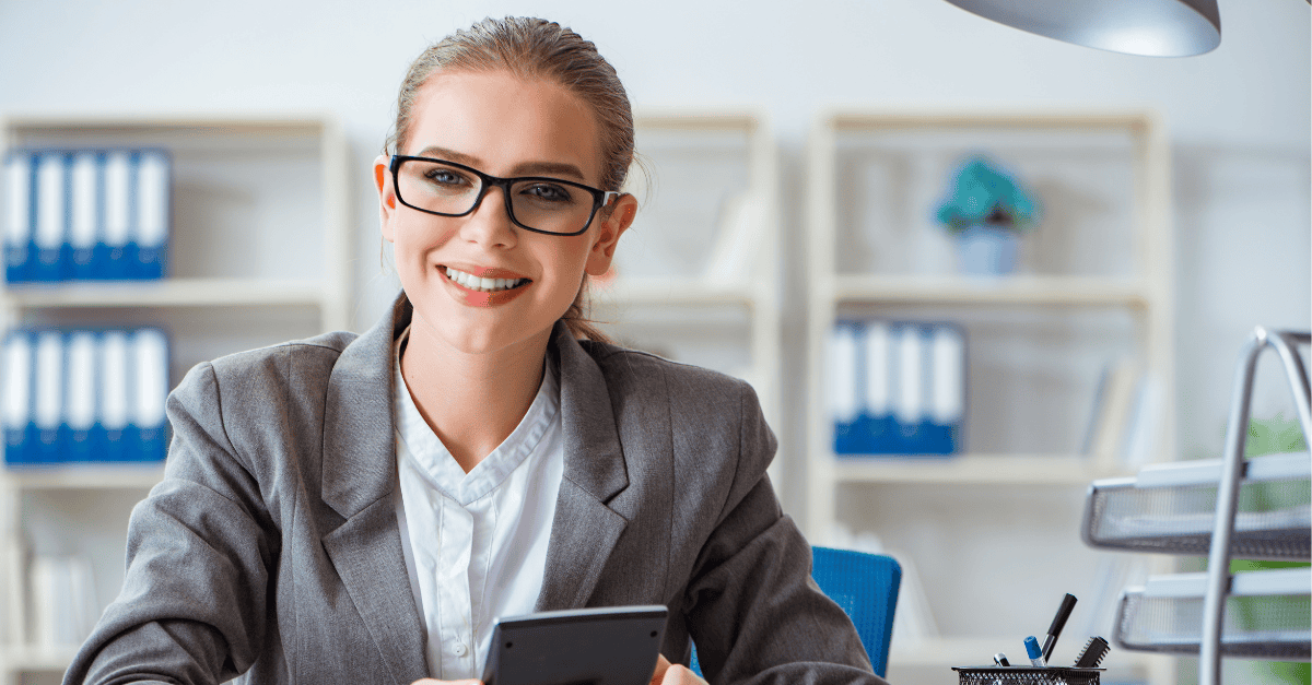 Businesswoman in office using smartphone for productivity and communication.