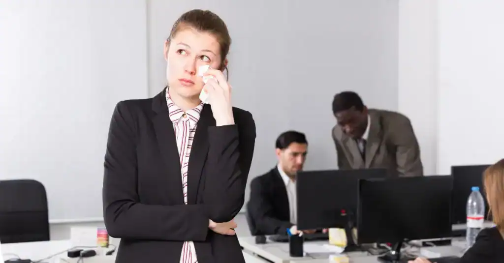 Businesswoman contemplating Lean strategies in an office setting.