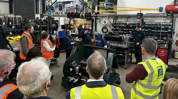 Workers and managers engaged in operational excellence workshop.