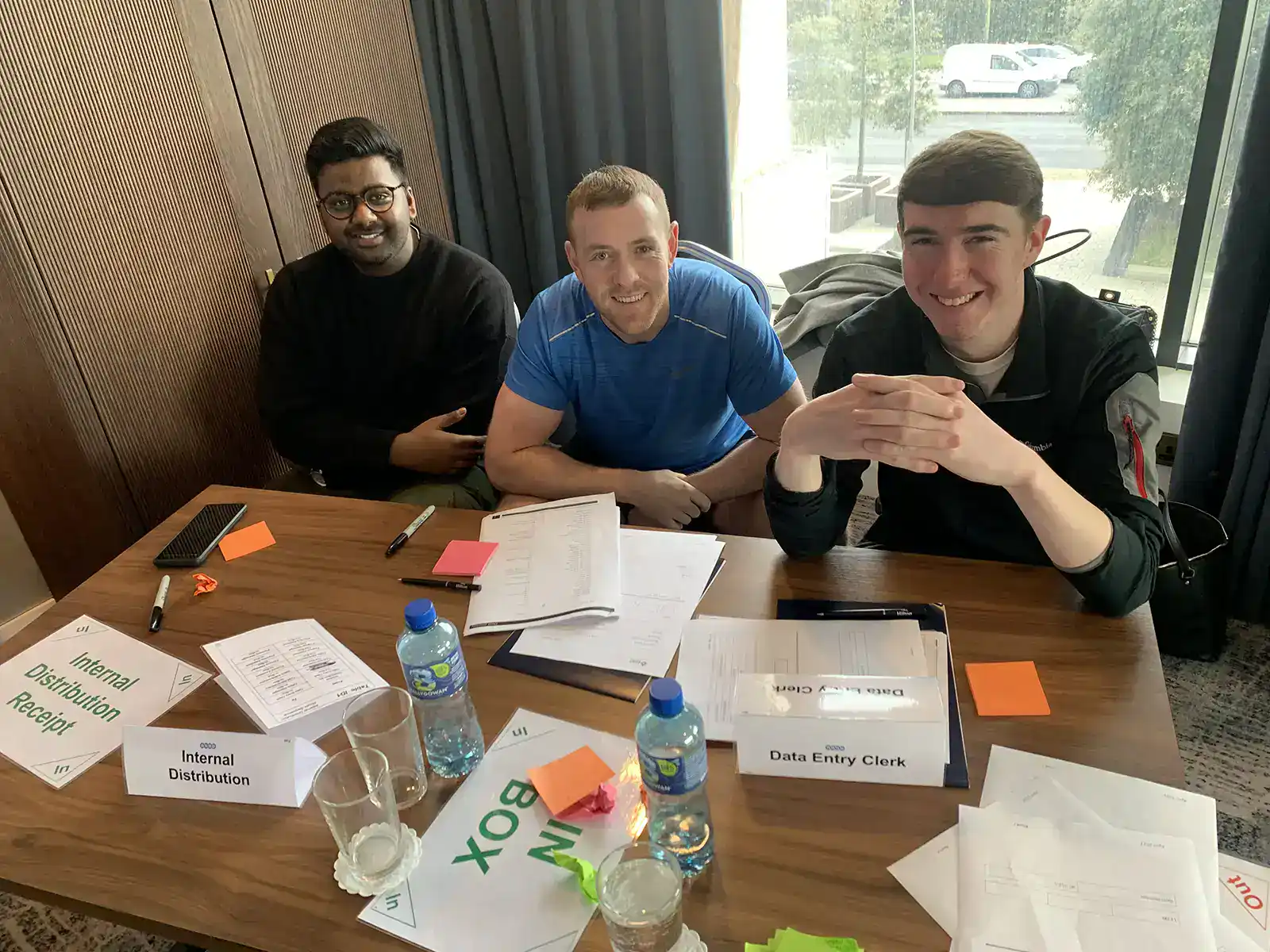 Young professionals collaborating at a Lean training workshop in Ireland.