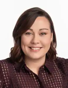 Professional woman smiling, representing business training and operational excellence in Ireland.